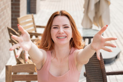 Portrait of young woman sitting on table