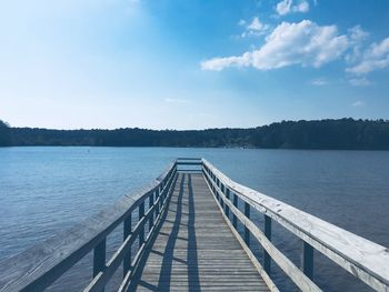 Pier over lake against sky