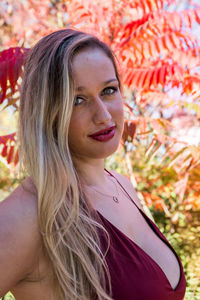 Portrait of smiling young woman standing at park