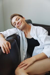 Portrait of young woman sitting at home