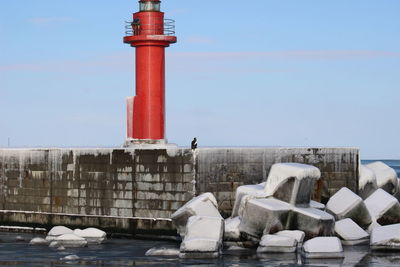 Lighthouse against sky during winter