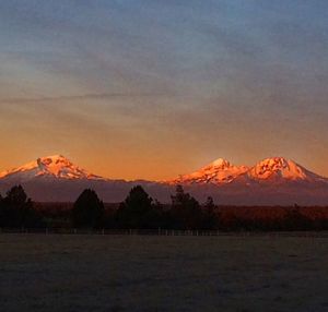 Scenic view of mountains against sky at sunset