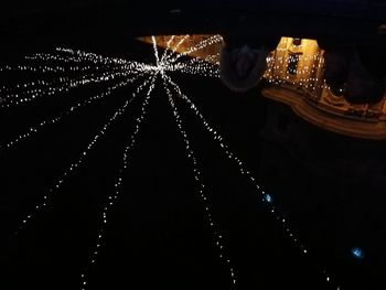 Close-up of illuminated lighting equipment against black background