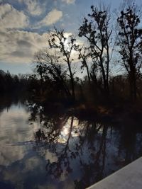 Scenic view of lake against sky at sunset