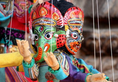 Close-up of colorful puppets hanging