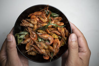 Cropped hand holding food