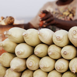Midsection of man selling sweetcorns at market stall
