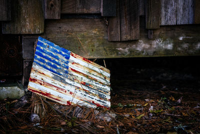 American flag on abandoned corrugated iron on field