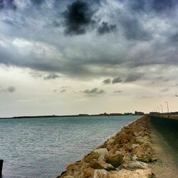 Scenic view of sea against cloudy sky