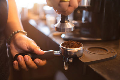 Midsection of man holding coffee