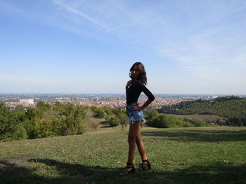 Full length of woman standing by sea against sky