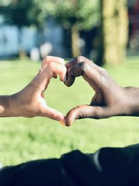 Close-up of hands holding heart shape