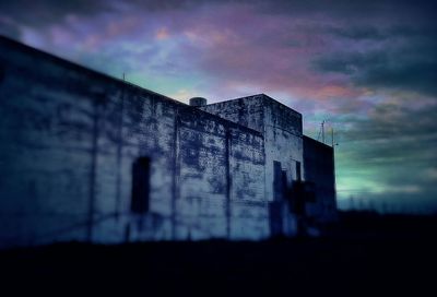 Built structures against sky at sunset