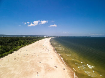 Scenic view of beach against blue sky