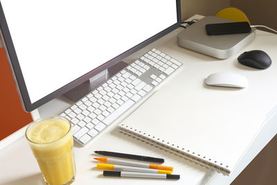 High angle view of coffee and laptop on table