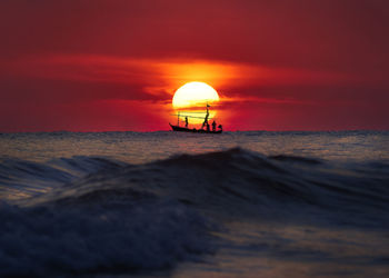 Scenic view of sea against orange sky