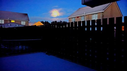 Illuminated buildings against sky at night
