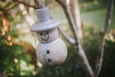 Close-up of old decoration hanging on tree