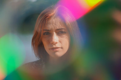 Funky portrait of a young woman with lens flare and light leaks