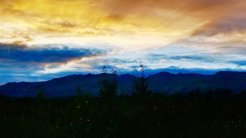 Scenic view of mountains against sky during sunset