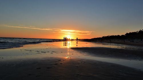 Scenic view of beach against sky during sunset