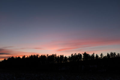 Silhouette trees against sky during sunset