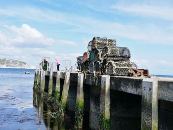 Built structure on beach against cloudy sky