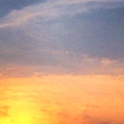 Low angle view of cloudy sky at sunset