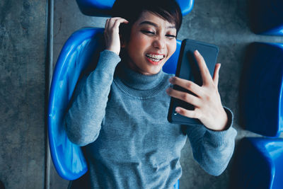 Young woman using mobile phone while sitting in car