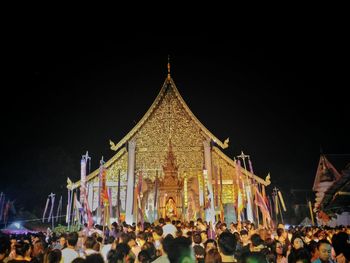 People in illuminated city at night