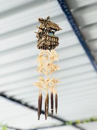 Low angle view of wind chime hanging from ceiling