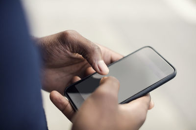Cropped image of man using mobile phone