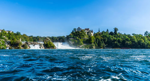 Scenic view of waterfall against sky