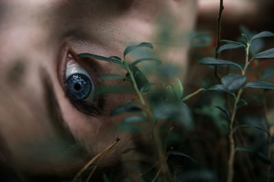 Close-up portrait of woman by plants