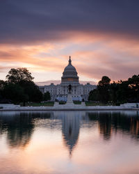 Reflection of building in lake at sunset