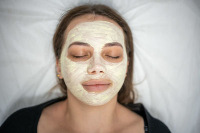 Close-up of woman with face mask resting at spa