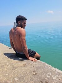 Man looking at sea against sky