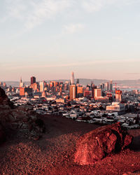 Buildings in city during sunset