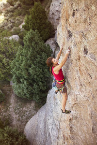 High angle view of female climber climbing mountain