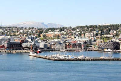 Townscape by sea against clear sky