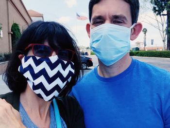 Portrait of couple wearing masks in us