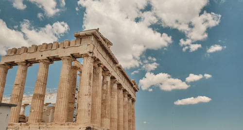 Low angle view of historical building against cloudy sky