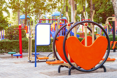 Empty chairs and table in park