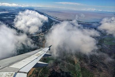 Cropped image of airplane flying over landscape