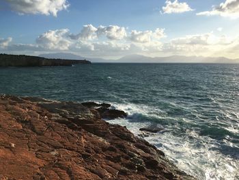 Scenic view of sea against cloudy sky