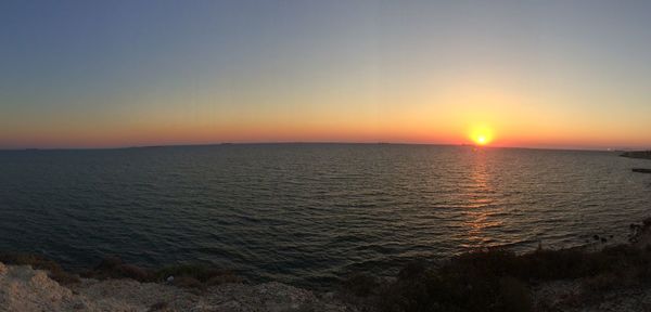 Scenic view of sea against orange sky