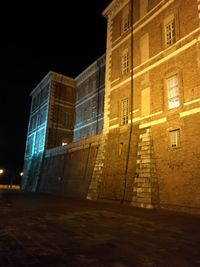 Low angle view of illuminated building at night