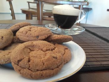 Close-up of coffee and cookies on table