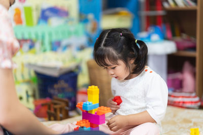 Close-up of girl playing with friend