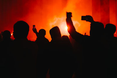 Silhouette people against during music festival